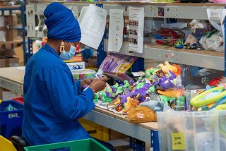 Woman cleaning and repairing toys.